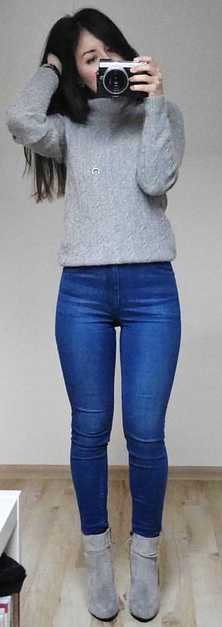 Grey sweater and blue denim jeans.