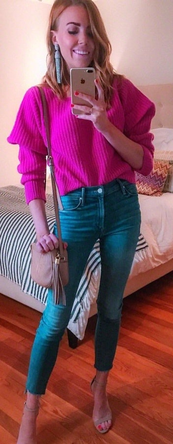 Pink sweater and blue skinny jeans.