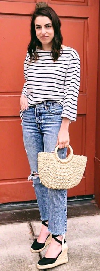 White and black striped long-sleeved shirt with handbag.