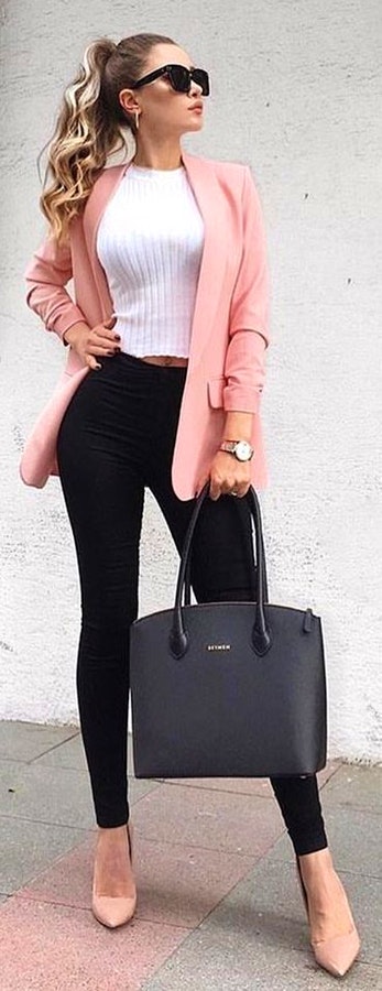 White crew-neck top and black fitted pants and orange blazer.