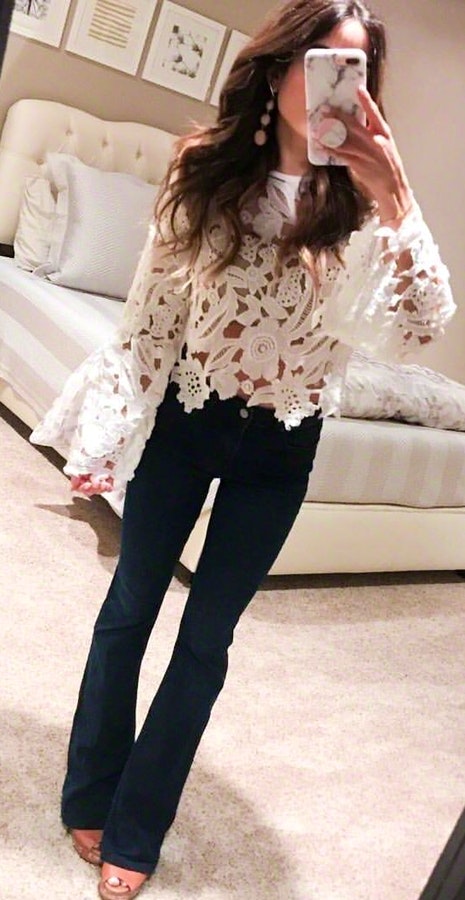 White long-sleeved blouse and black pants.