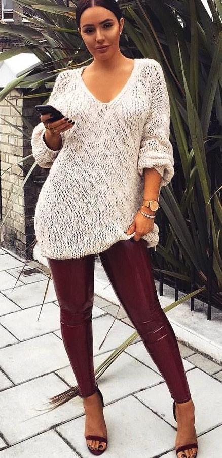 White long-sleeved knitted v-neck top and red jeans.