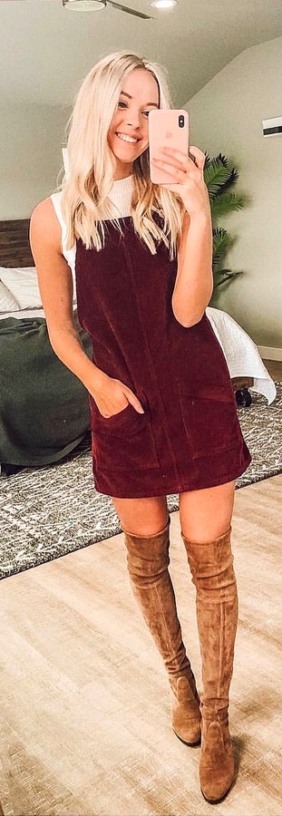 White sleeveless top, purple mini dress, and pair of brown thigh high boots outfit.