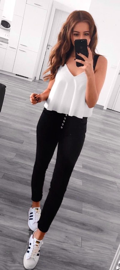 White v-neck sleeveless blouse and black leggings outfit.