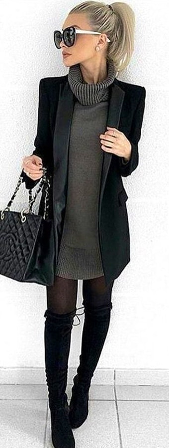 Woman in black cardigan and gray sweater.