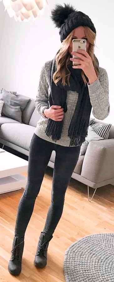 Woman in black scarf and grey sweater.