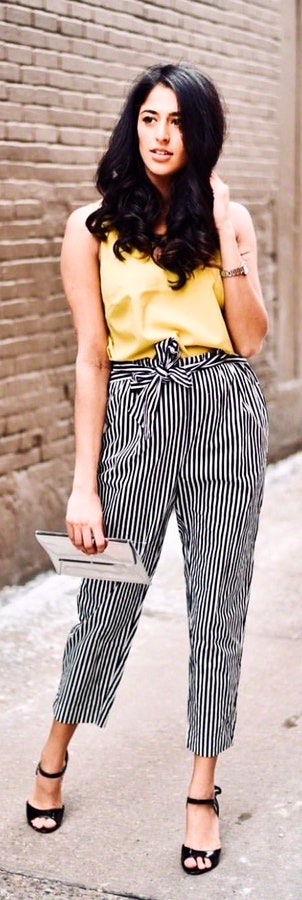 Yellow sleeveless top and black and white stripe pants. Pic originally posted by nicolemehta