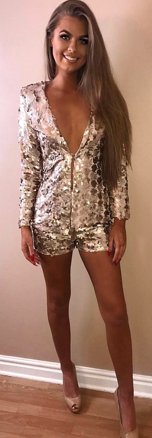 silver sequined zip-up blazer and short shorts.