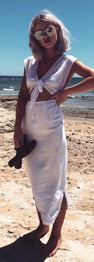 white crop-top and maxi skirt near seashore during daytime.