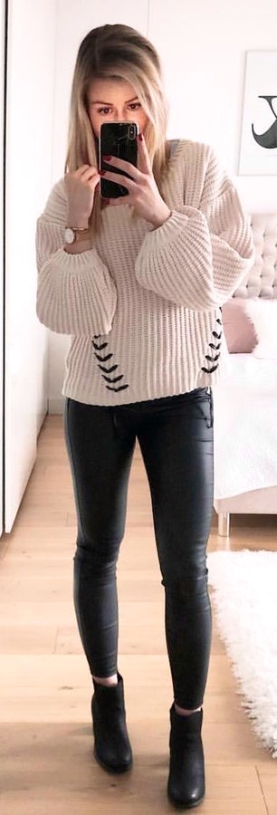 white sweater and black skinny jeans.