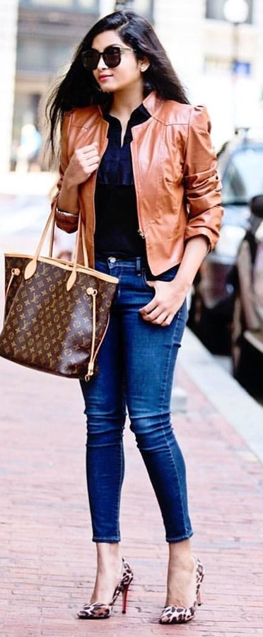 Brown collared full-zip jacket carrying brown Louis Vuitton Monogram tote bag.