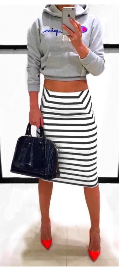 Gray Champion pullover hoodie and white striped skirt with black leather handbag.