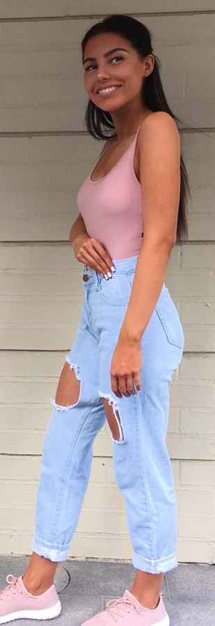 Pink spaghetti strap top and blue jeans.