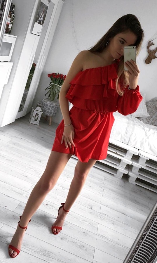 Red one-shoulder dress with red high heels.