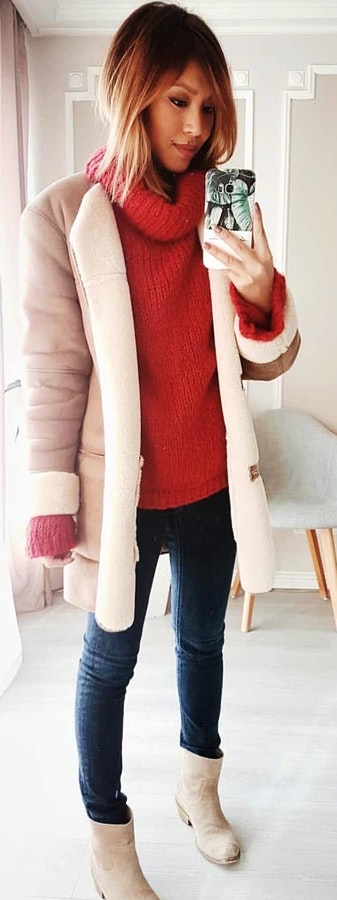 Red sweater, white coat, blue jeans, and pair of white leather chunky heeled booties.