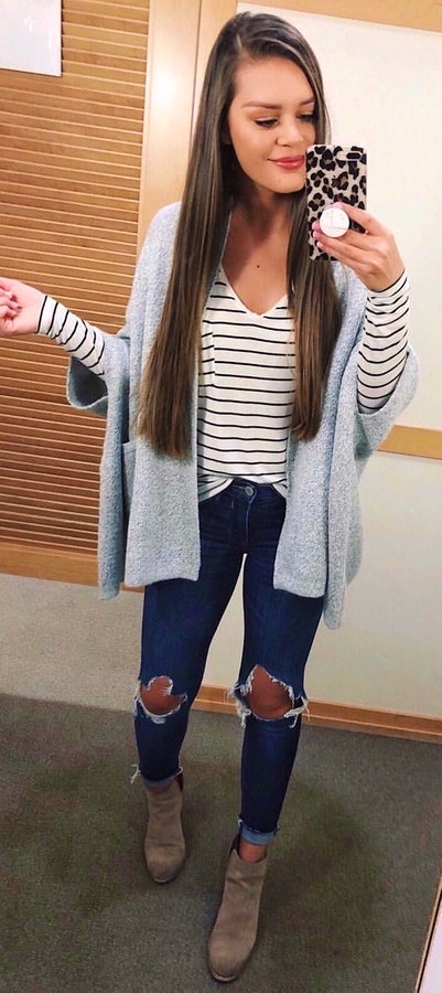 Striped shirt, grey cardigan, and distressed jeans.