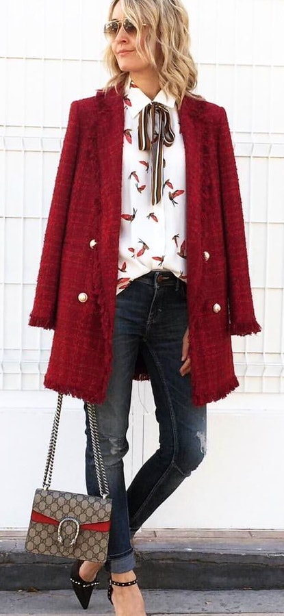 White and red floral shirt and red button-up jacket and distressed wash skinny jeans.