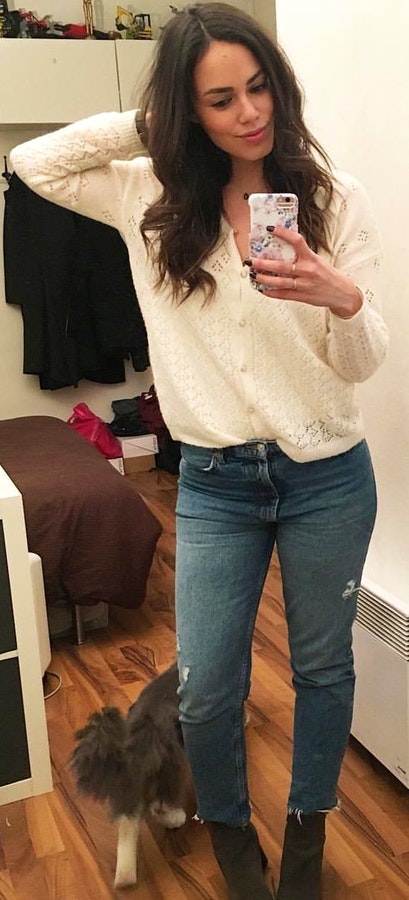White button-up sweater and blue jeans.