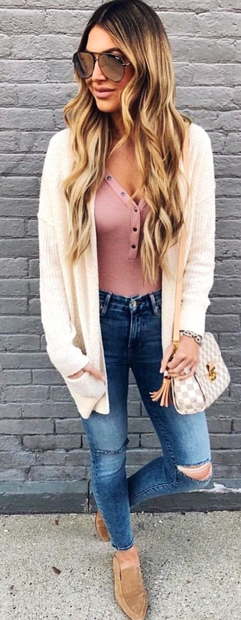 White cardigan with pink blouse and blue denim jeans.