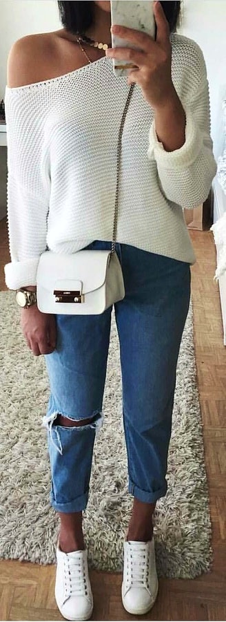 White mesh long-sleeve top, blue jeans with white shoes and handbag.