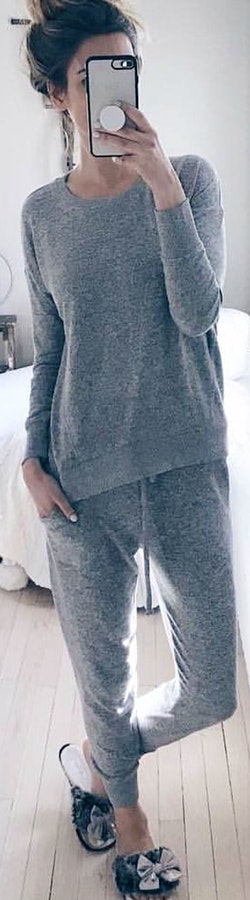 Woman wearing gray pajama set.