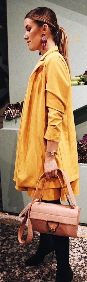 Yellow coat, pink leather 2-way handbag.
