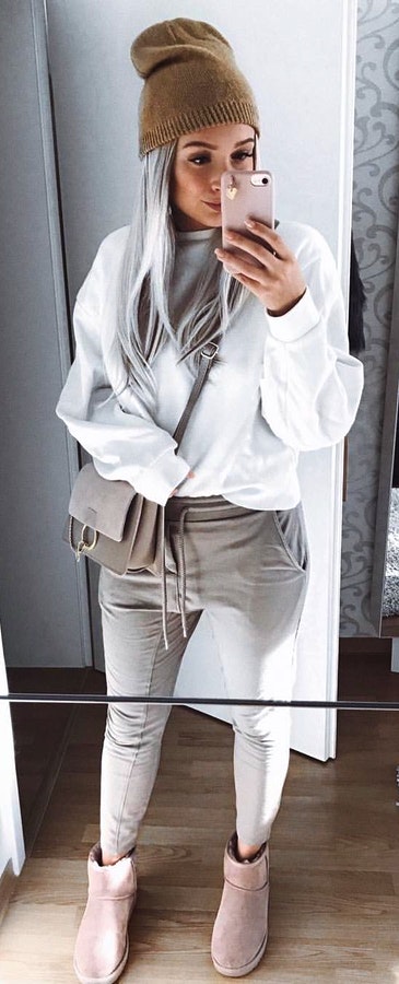 white sweater with gray drawstring sweatpants.