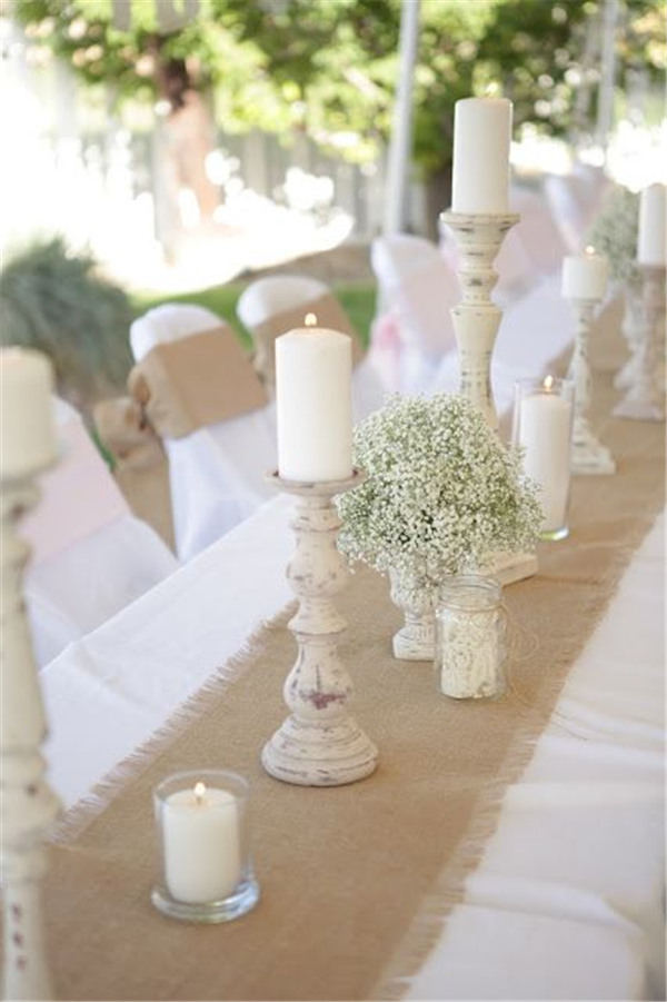 Burlap Runner Over A Simple White Table Cloths And Rustic Candle Holder Centerpieces