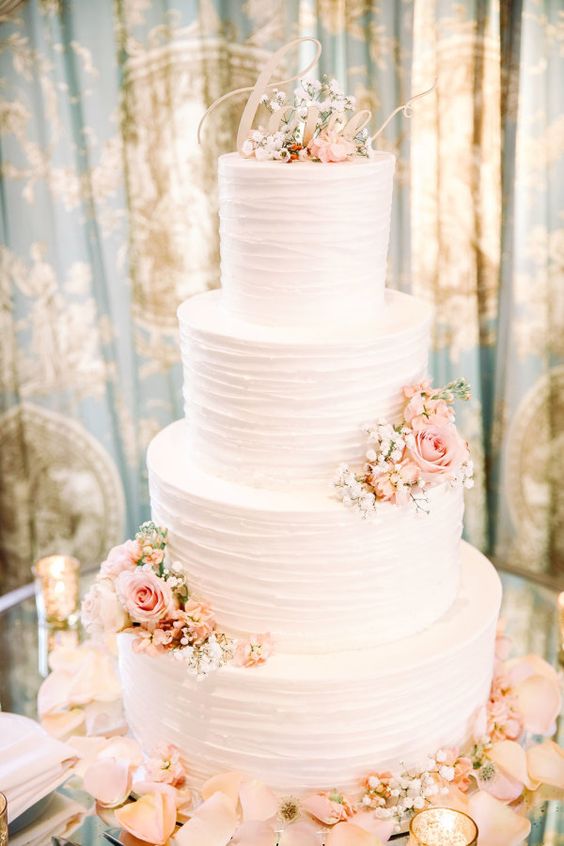 Pretty pink petal accented wedding cake