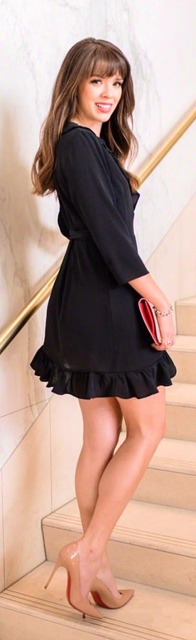Woman wearing black elbow sleeved mini dress.