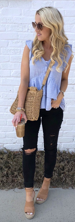 Woman with brown knitted bag near white wall during daytime.