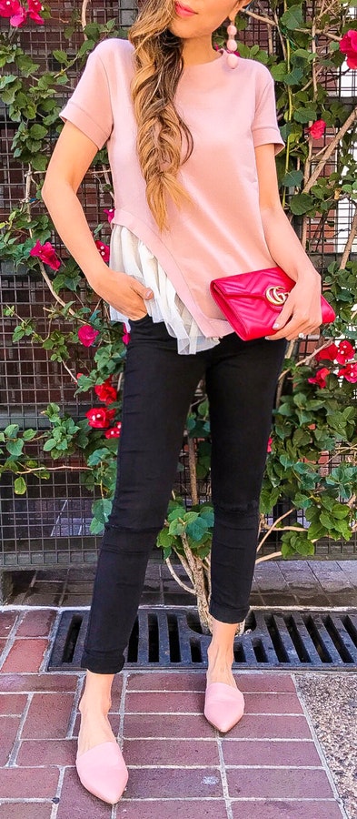 Women's pink T-shirt, black pants and pink leather pointed toe sandals.