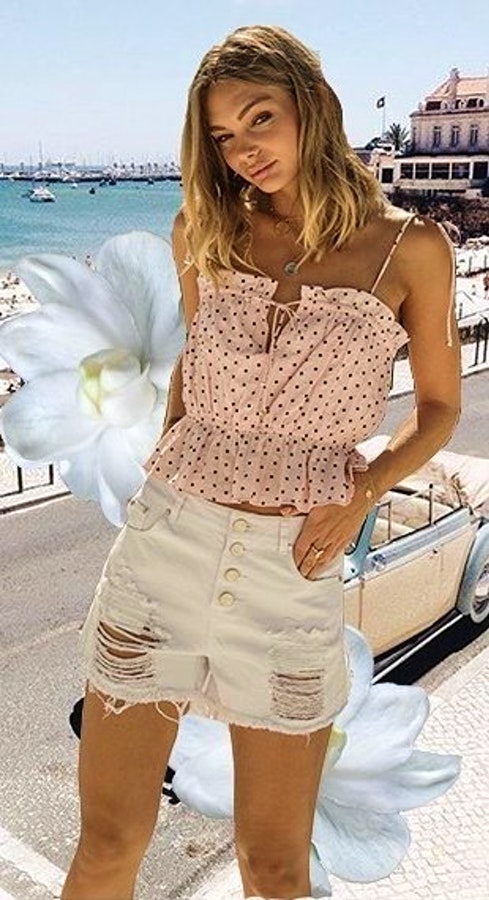 Womens beige polka dotted spaghetti strap top and white knitted shorts.
