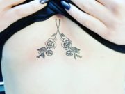 Small flowers sternum tattoo. Pic by josmoontattoo
