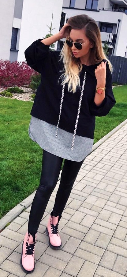 Women's black and grey hoodie with black leggings outfit.