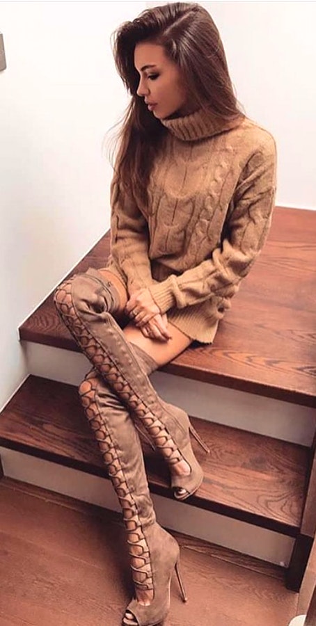 Women's brown turtle-neck sweatshirt and brown lace-front knee-high heeled boots outfit.