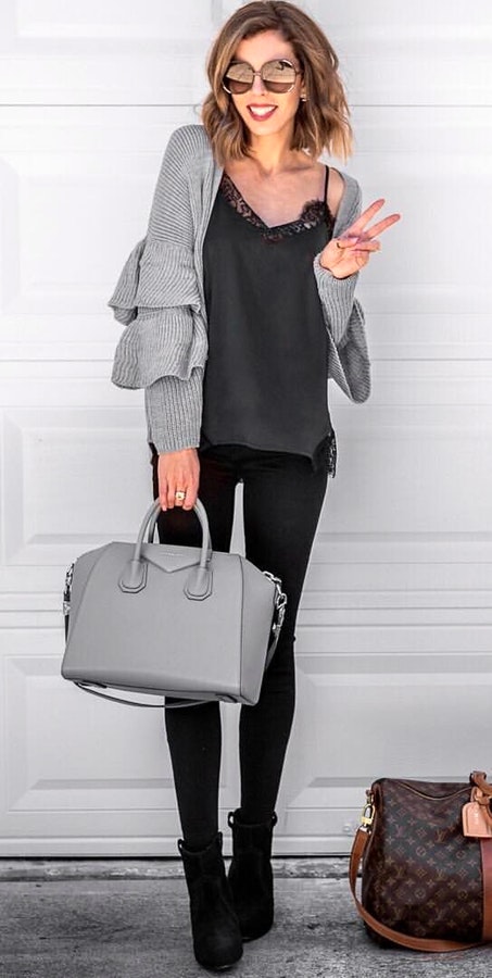 Women's gray cardigan with black leggings.