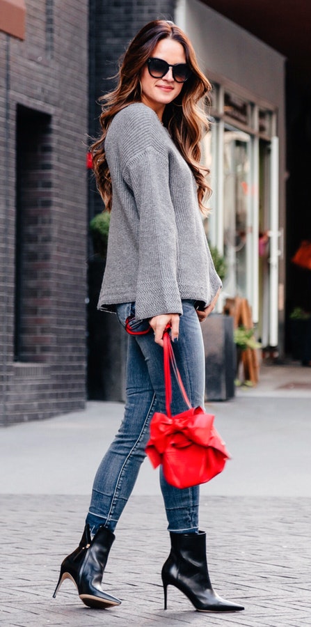 Women's gray cardigan with blue jeans.