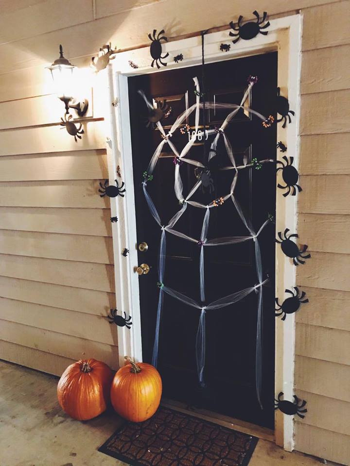 Door Decorated with DIY Web, Crab and Pumpkins For Halloween.