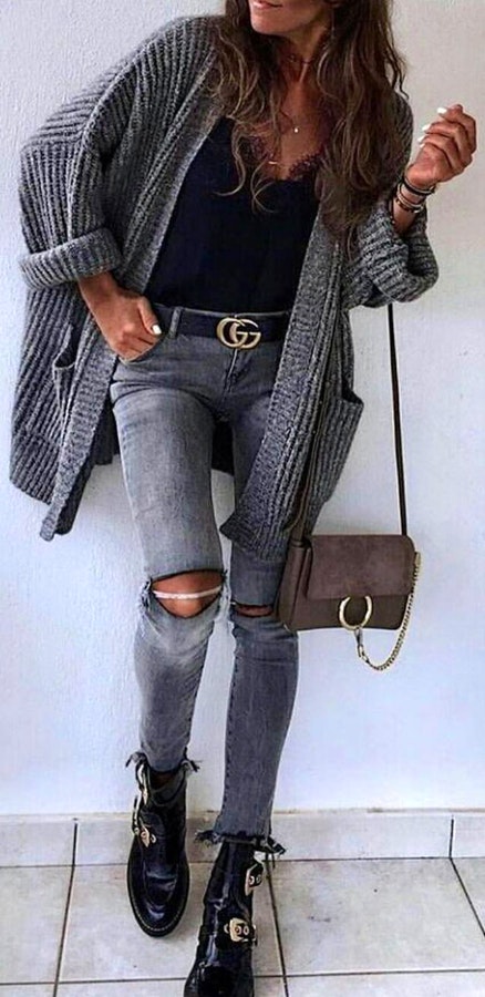 Gray knitted long cardigan with distressed jeans, boots, and bag outfit.