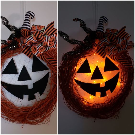 Happy Jack o lantern lighted Halloween pumpkin wreath.