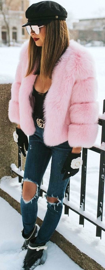 Pink fur jacket with distressed blue denim jeans outfit.
