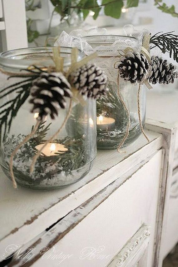 Glass Jar Candle Holders with Fake Snow, Greenery and Pinecones.