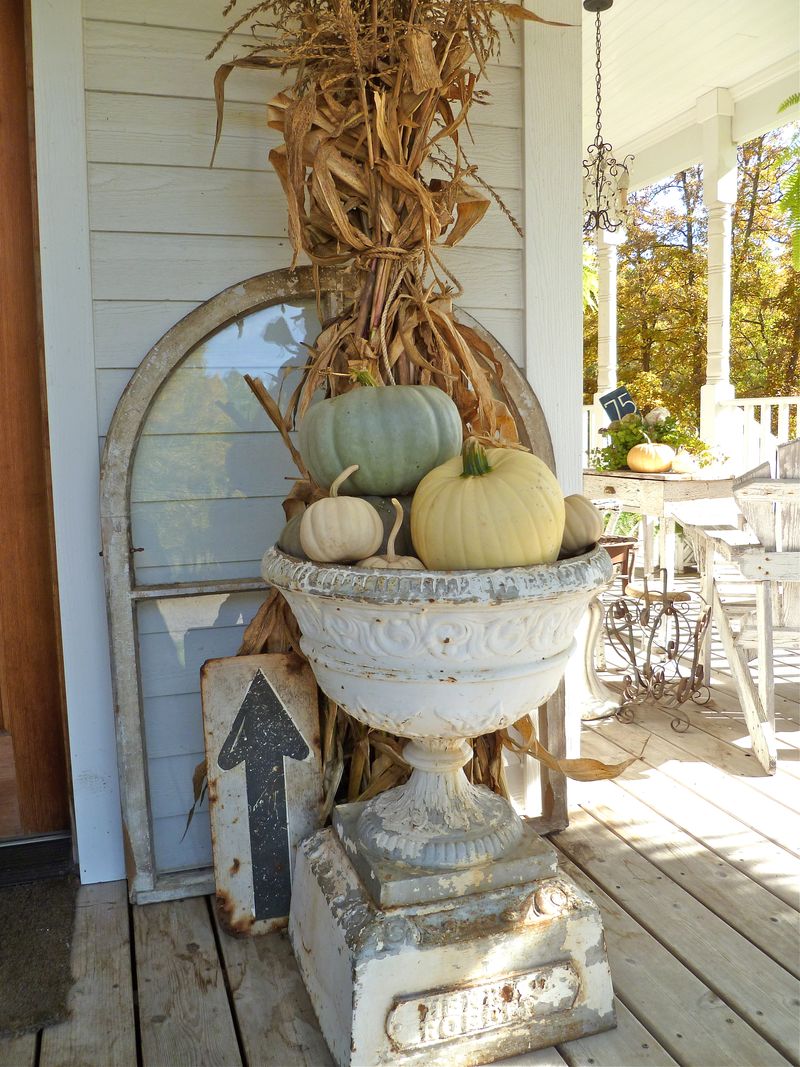 An urn of off-beat colored pumpkins.