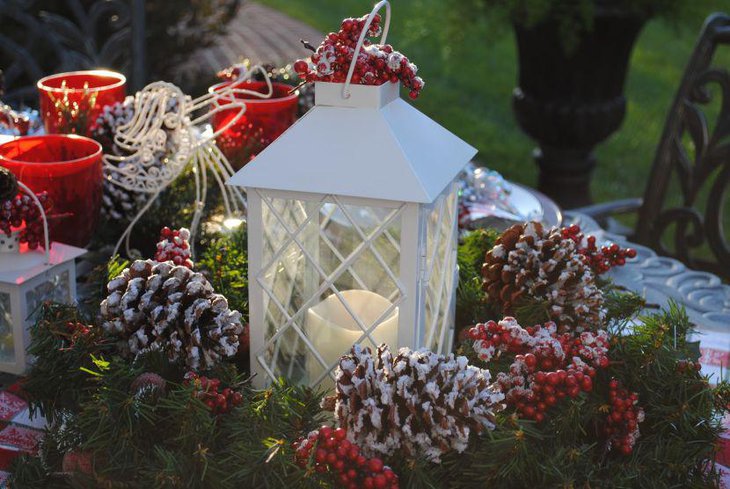 Classy Wreath and Lit Lantern Centerpiece for an Outdoor Christmas Table.