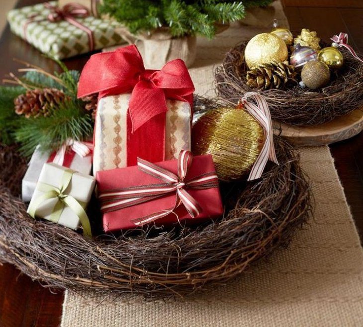 Gorgeous DIY Nest Christmas Table Centerpiece Filled with Gift Boxes, Ornaments, and Pinecones.