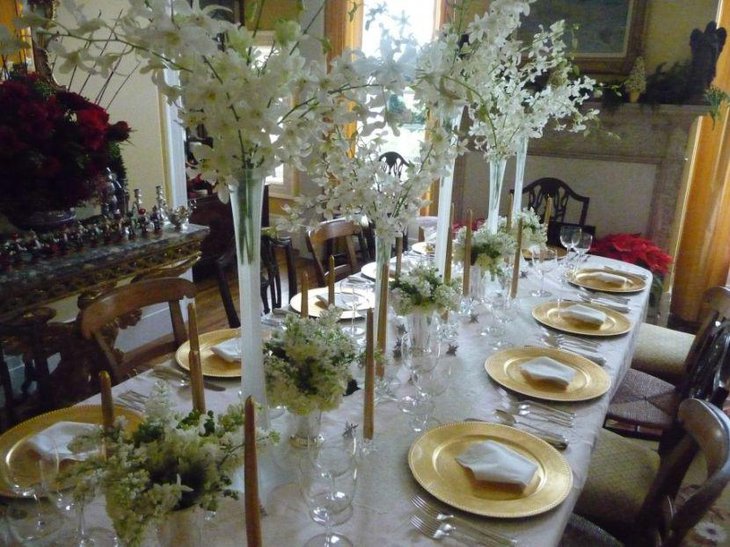 White Tablecloth and Napkinswith Tall White Floral Arrangements.