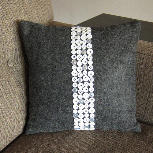 Make a designer pillow cover with buttons.