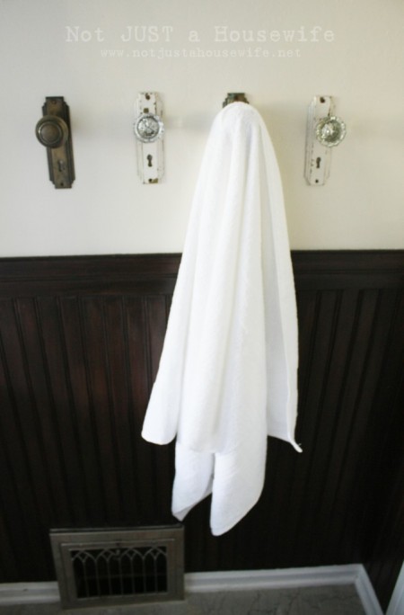 Mount retro doorknobs to the wall and hang towels on them.