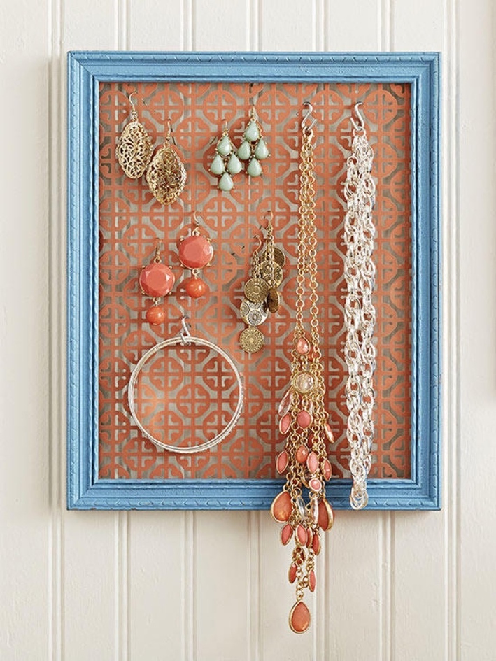 A frame and decorative piece of metal. Jewellery Organizer